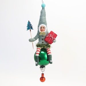 Spun Cotton Blue Holiday Elf Child On Green Glass Ball Christmas Ornament